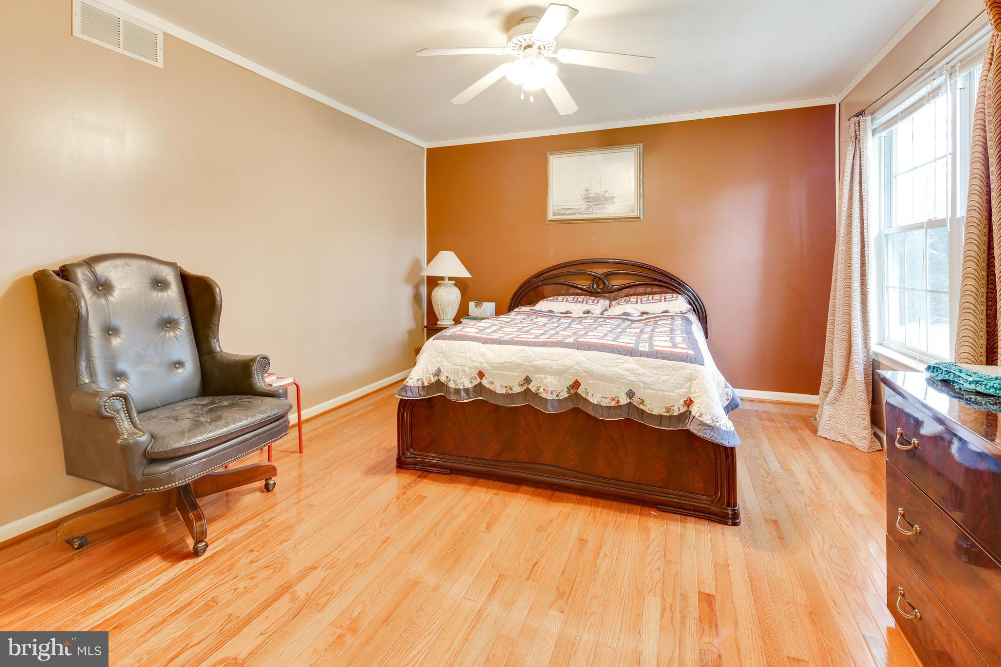 6375 Waterloo Road Elkridge, MD 21075 - Photo 17 of 30 a bedroom with a bed and a dresser with mirror