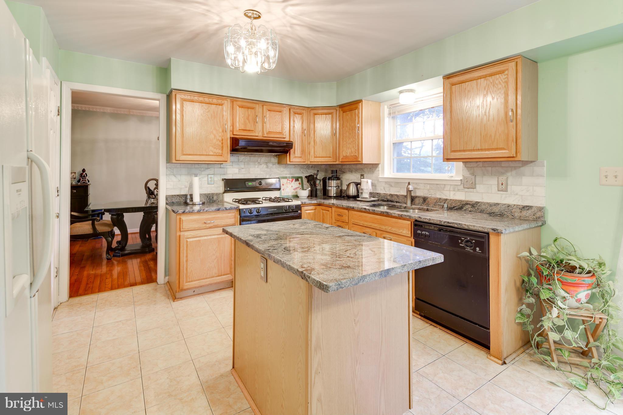 6375 Waterloo Road Elkridge, MD 21075 - Photo 3 of 30 a kitchen with stainless steel appliances granite countertop a sink stove and cabinets