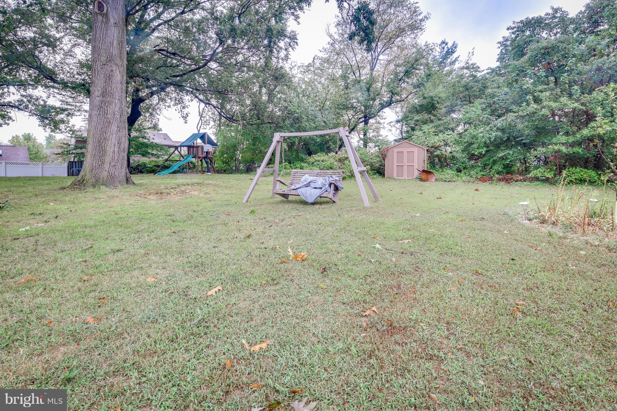 6375 Waterloo Road Elkridge, MD 21075 - Photo 26 of 30 a backyard of a house with lots of green space and fountain