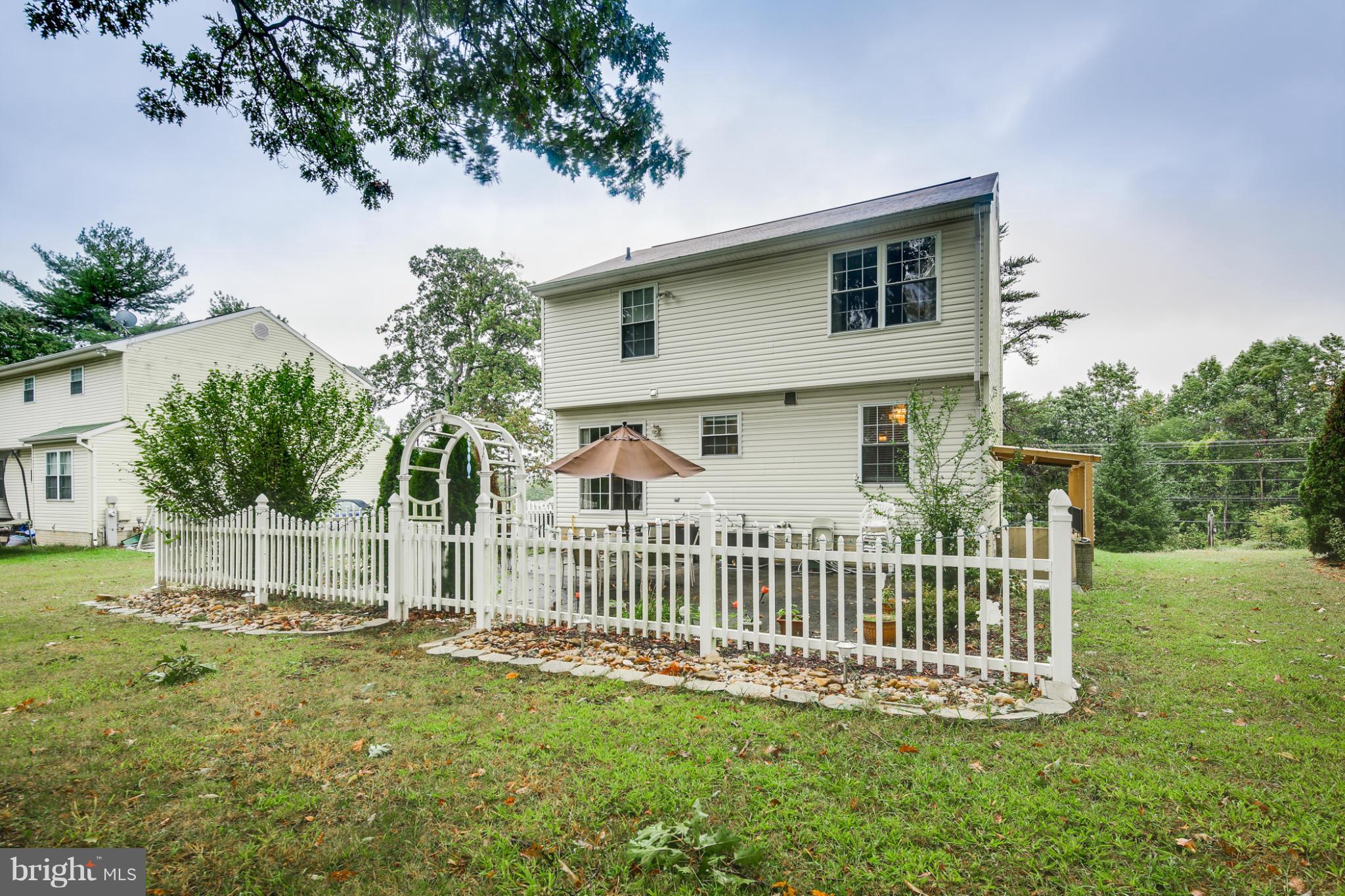 6375 Waterloo Road Elkridge, MD 21075 - Photo 27 of 30 a view of a house with a yard and a garden