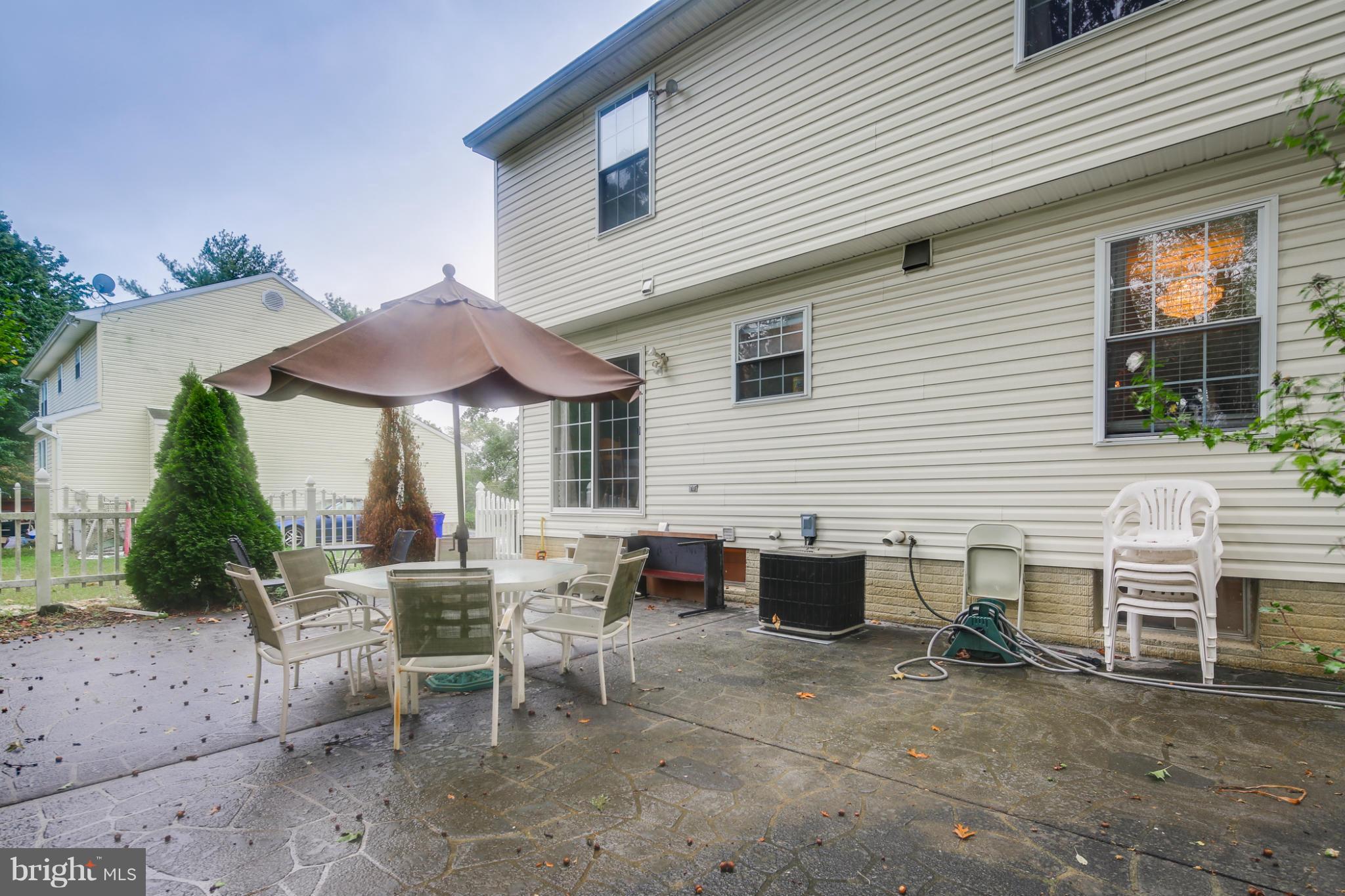 6375 Waterloo Road Elkridge, MD 21075 - Photo 28 of 30 a view of a patio with table and chairs under an umbrella
