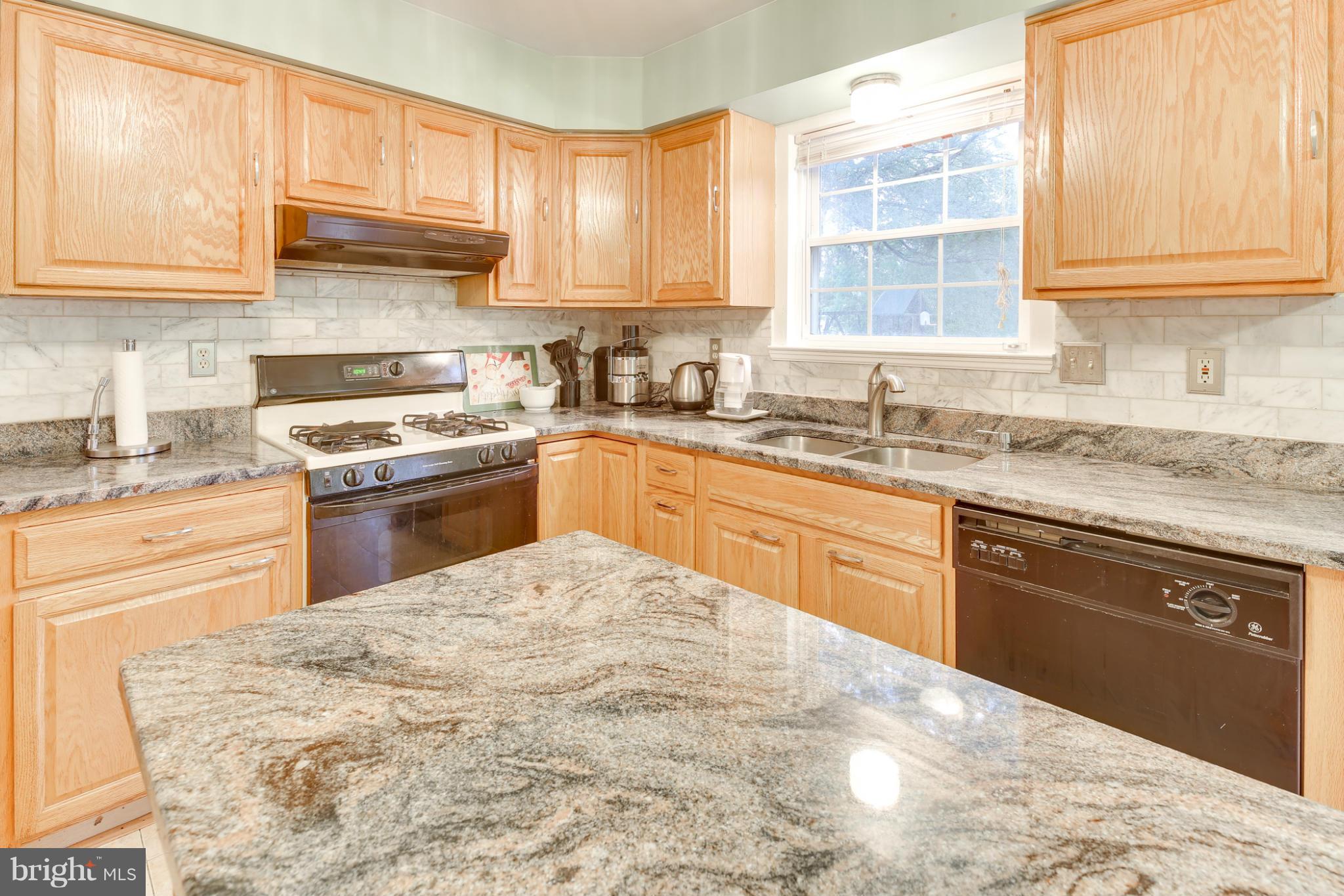 6375 Waterloo Road Elkridge, MD 21075 - Photo 4 of 30 a kitchen with a sink stove top oven and cabinets