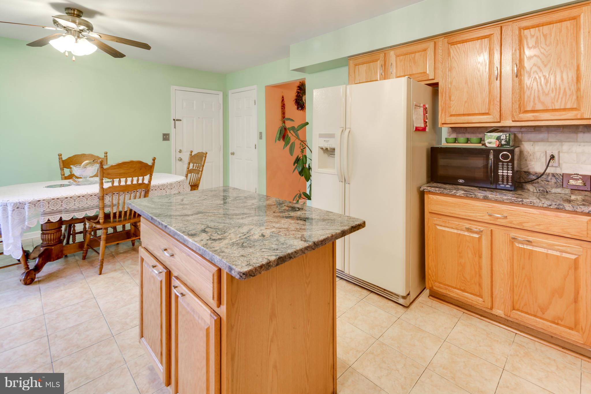 6375 Waterloo Road Elkridge, MD 21075 - Photo 6 of 30 a kitchen with stainless steel appliances granite countertop a refrigerator a sink and a stove