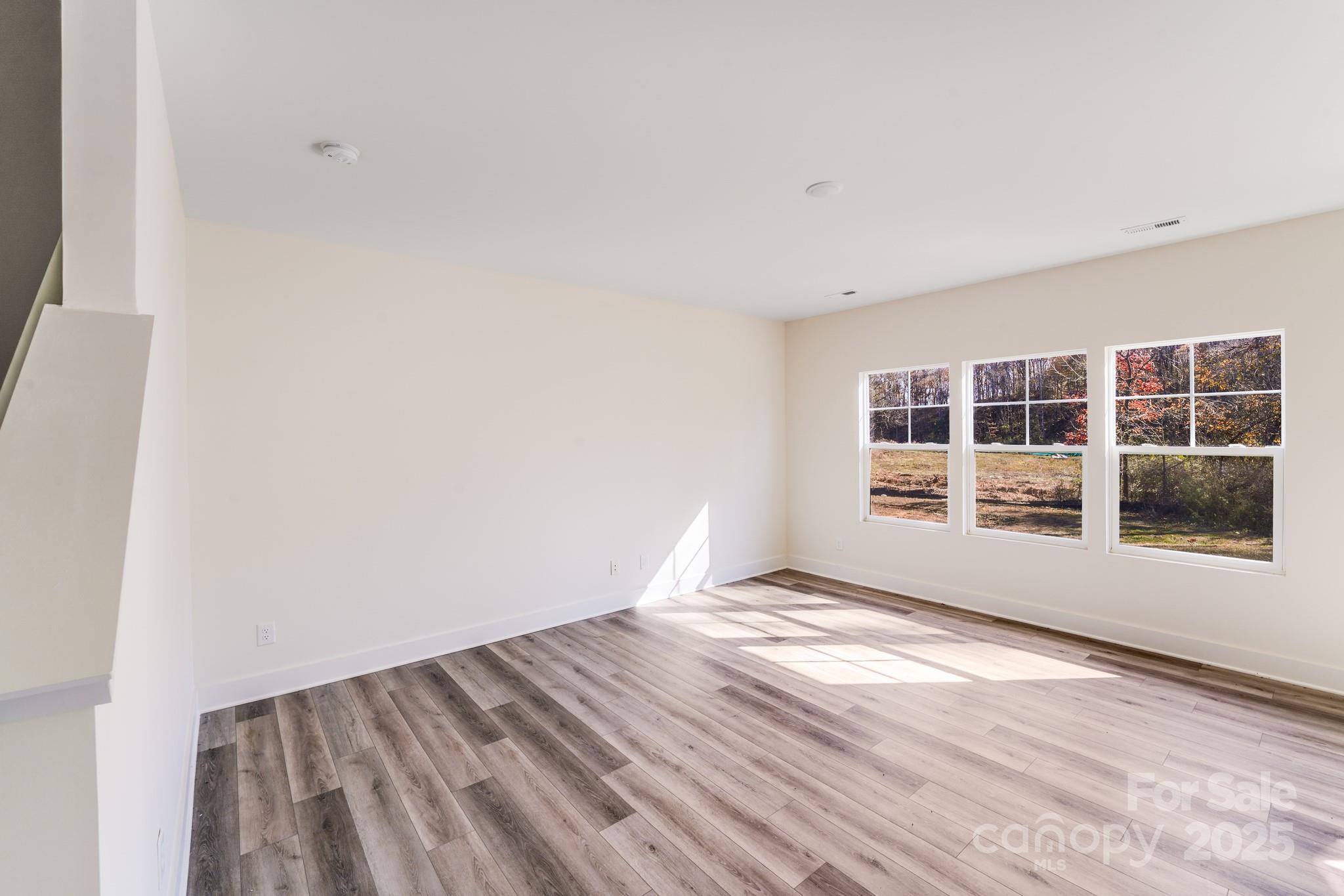 232 Sugar Hill Road Troutman, NC 28166 - Photo 12 of 37 a view of empty room with windows