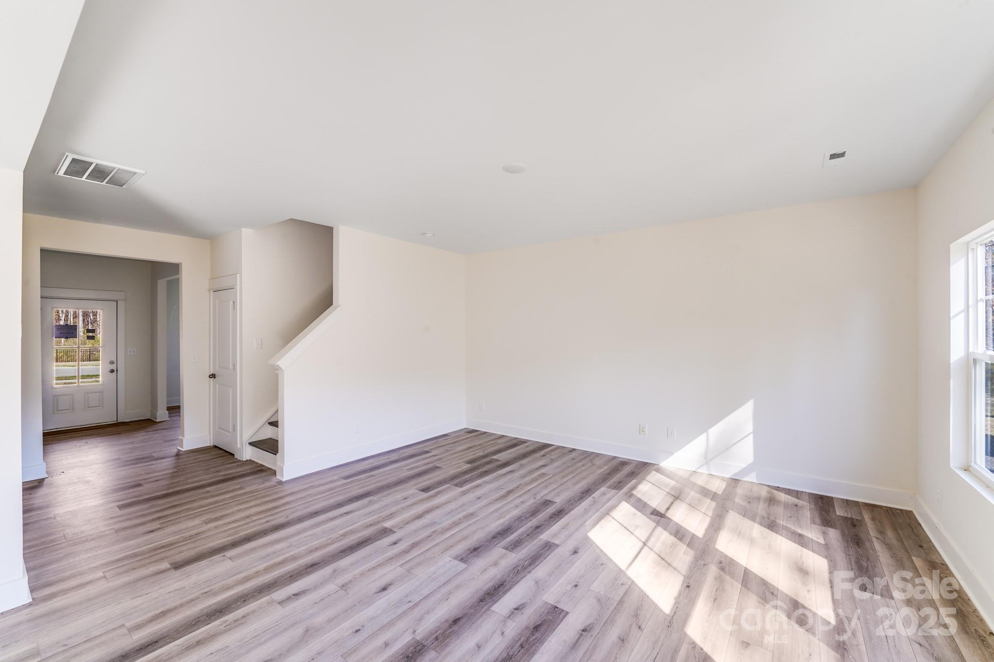 232 Sugar Hill Road Troutman, NC 28166 - Photo 13 of 37 a view of empty room with wooden floor