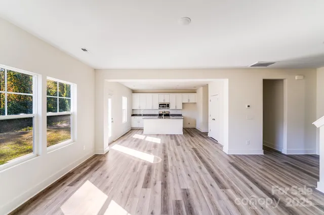 a view of kitchen with wooden floor and electronic appliances