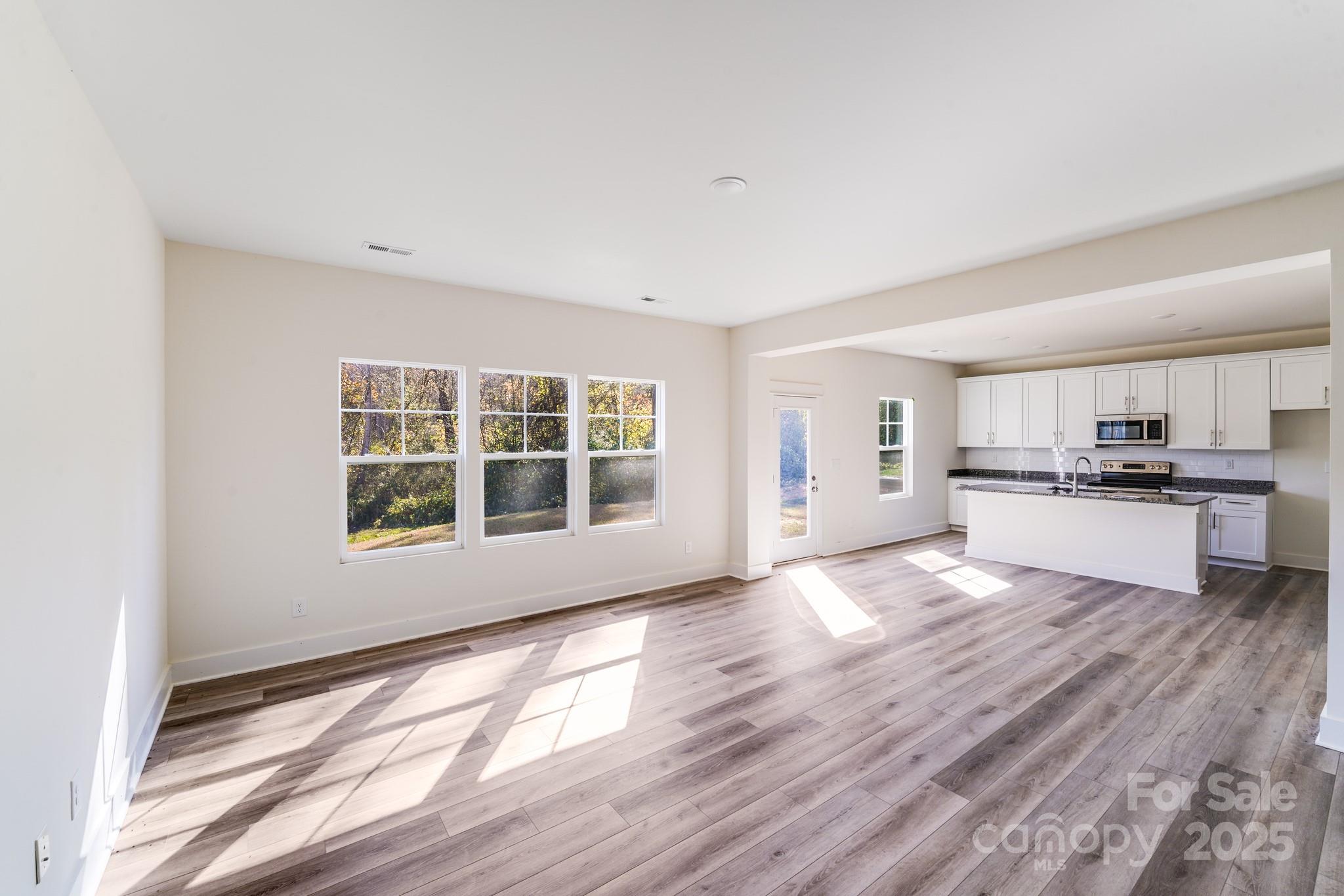232 Sugar Hill Road Troutman, NC 28166 - Photo 16 of 37 a view of kitchen with wooden floor and electronic appliances
