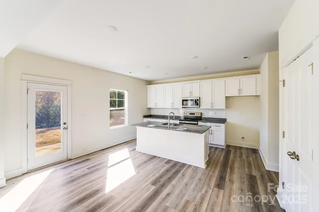 a kitchen with a stove a sink and a refrigerator