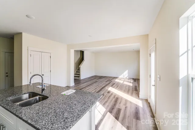 a view of livingroom with hardwood floor and kitchen view
