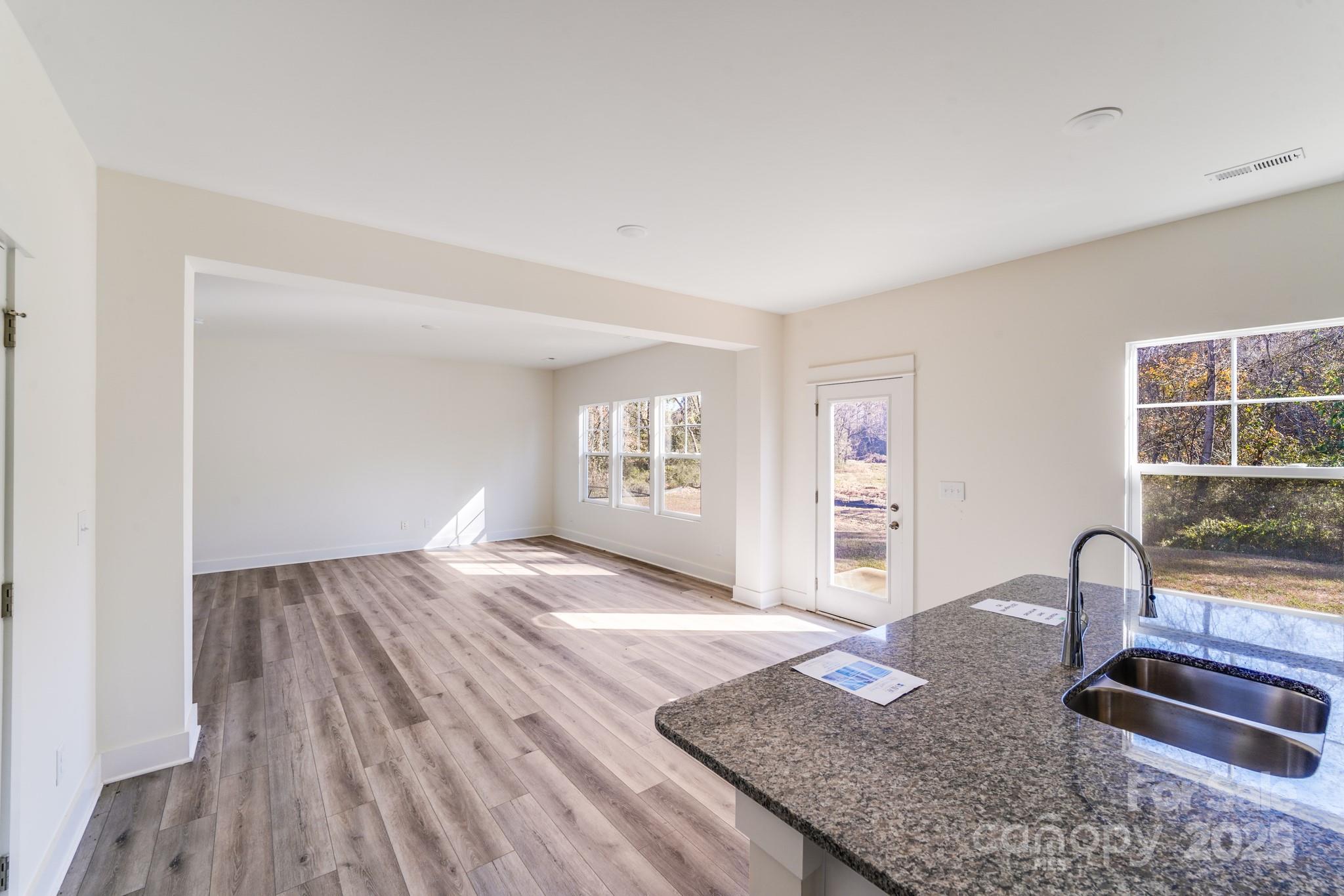 232 Sugar Hill Road Troutman, NC 28166 - Photo 21 of 37 a view of livingroom with hardwood floor and kitchen view