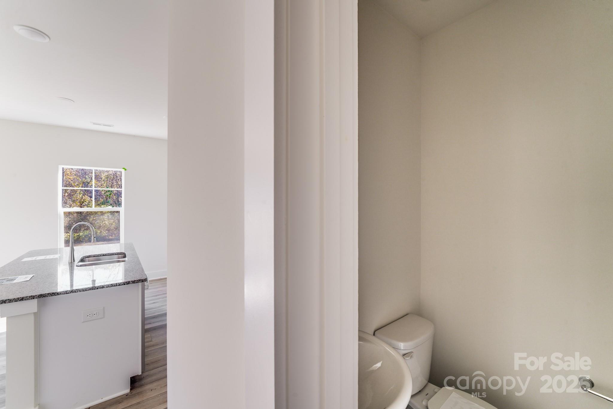 232 Sugar Hill Road Troutman, NC 28166 - Photo 22 of 37 a white toilet sitting next to a window