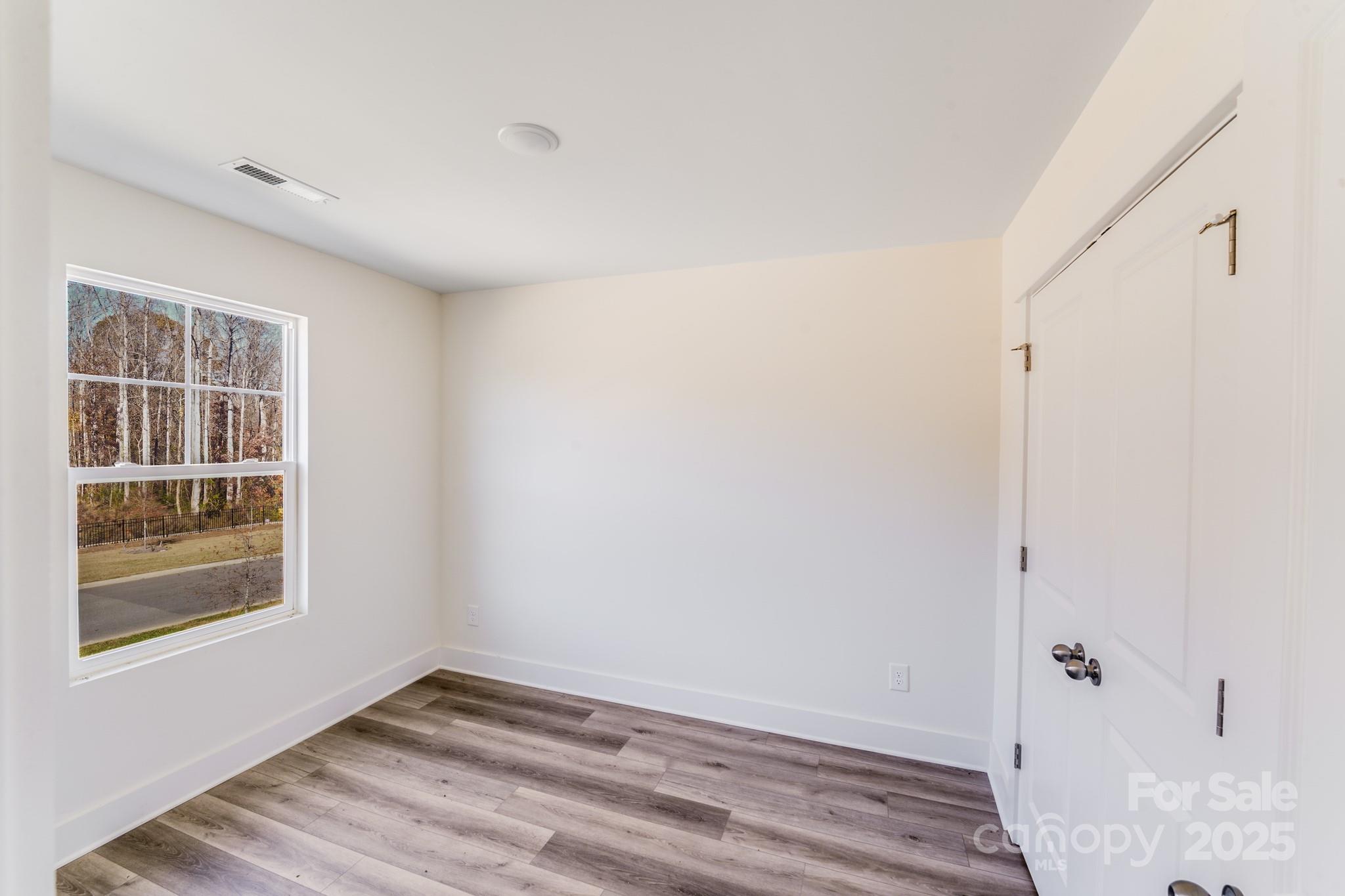 232 Sugar Hill Road Troutman, NC 28166 - Photo 28 of 37 a view of an empty room with wooden floor and a window