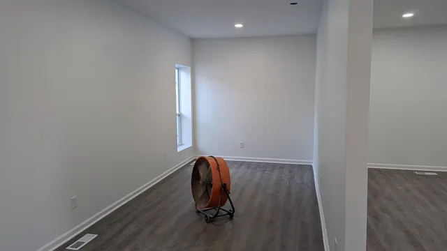 a view of room with wooden floor