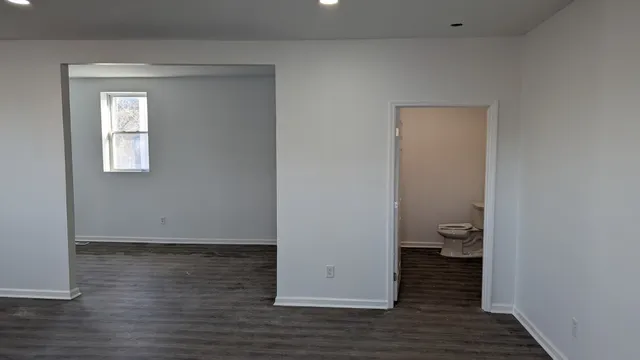 a view of a bathroom with wooden floor