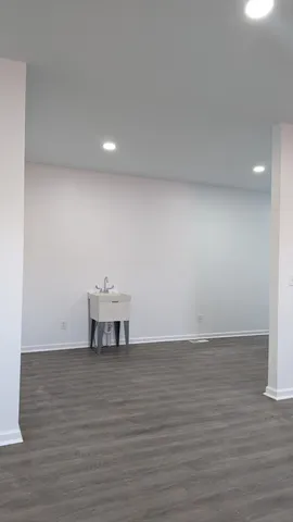 a view of a room with wooden floor