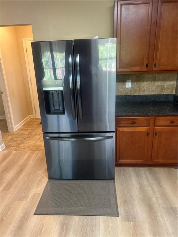 22 Pawnee Trail Fort Mitchell, AL 36856 - Photo 12 of 40 Stainless steel French door refrigerator, wood-finish flooring, cherry wood cabinetry, dark stone-finish countertop, and tiled backsplash