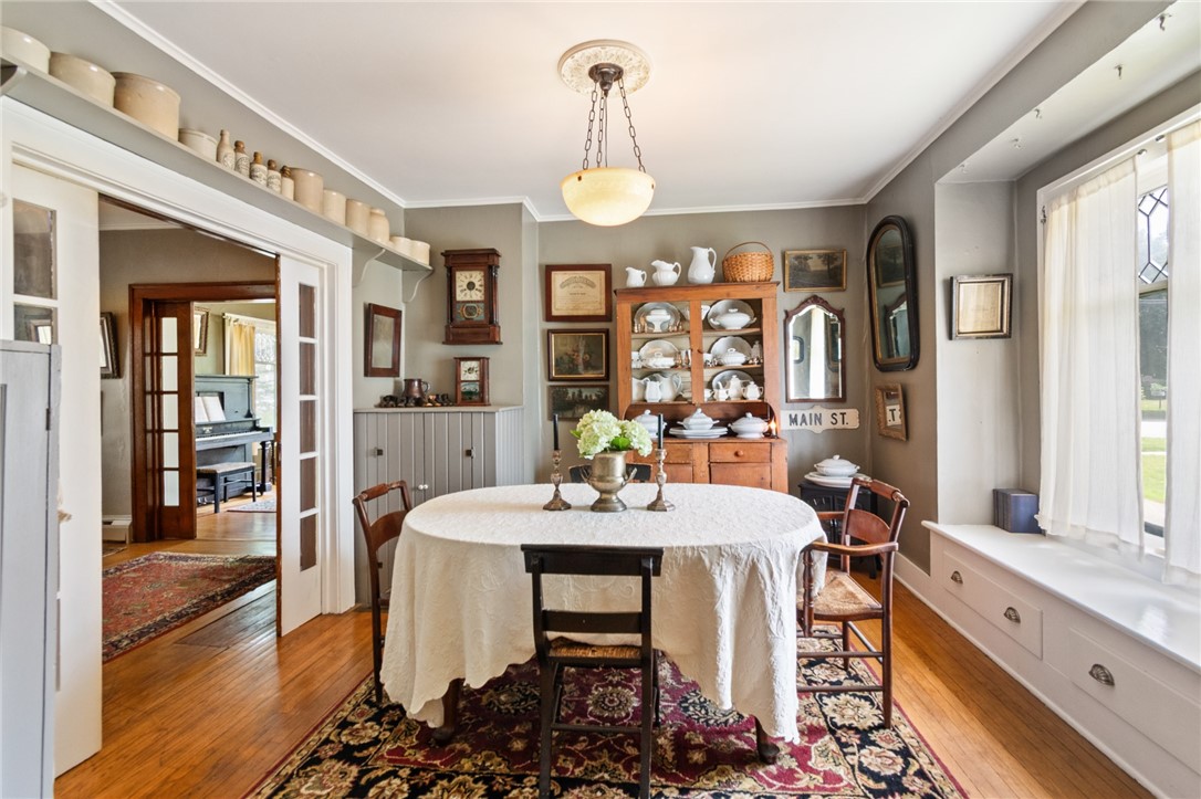 4007 Ridge Road Williamson, NY 14589 - Photo 20 of 34 The charm of a vintage window seat and leaded glass in this formal dining area