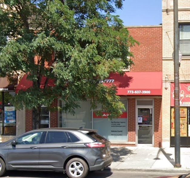 a front view of a building with trees