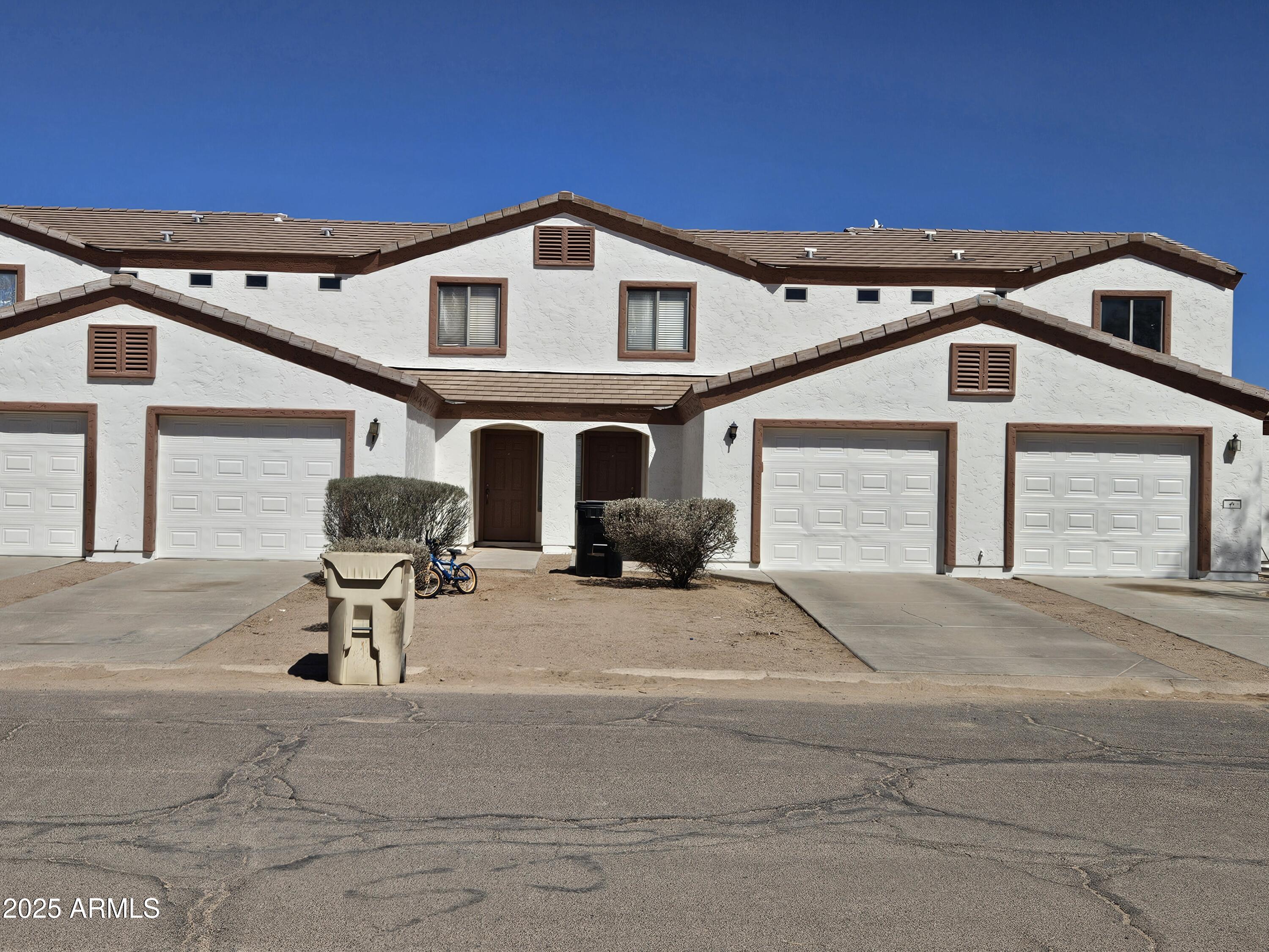 14091 South Berwick Road, Unit 4 Arizona City, AZ 85123 - Photo 1 of 10 a front view of a house with a yard