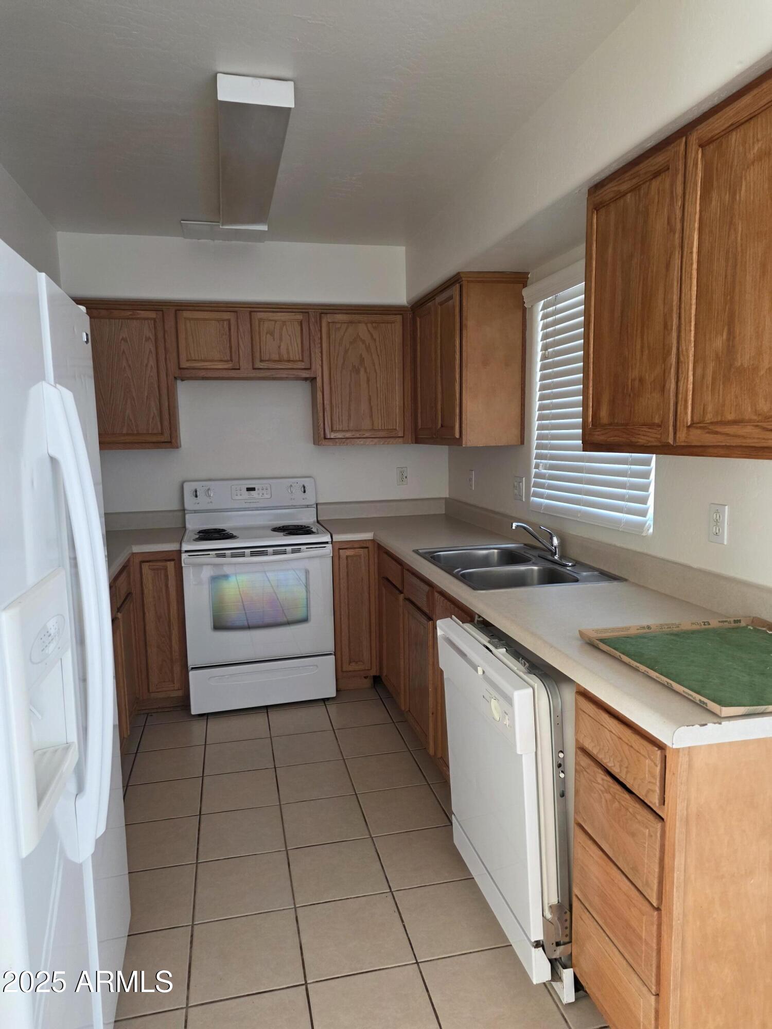 14091 South Berwick Road, Unit 4 Arizona City, AZ 85123 - Photo 2 of 10 a kitchen with a sink a stove and a refrigerator