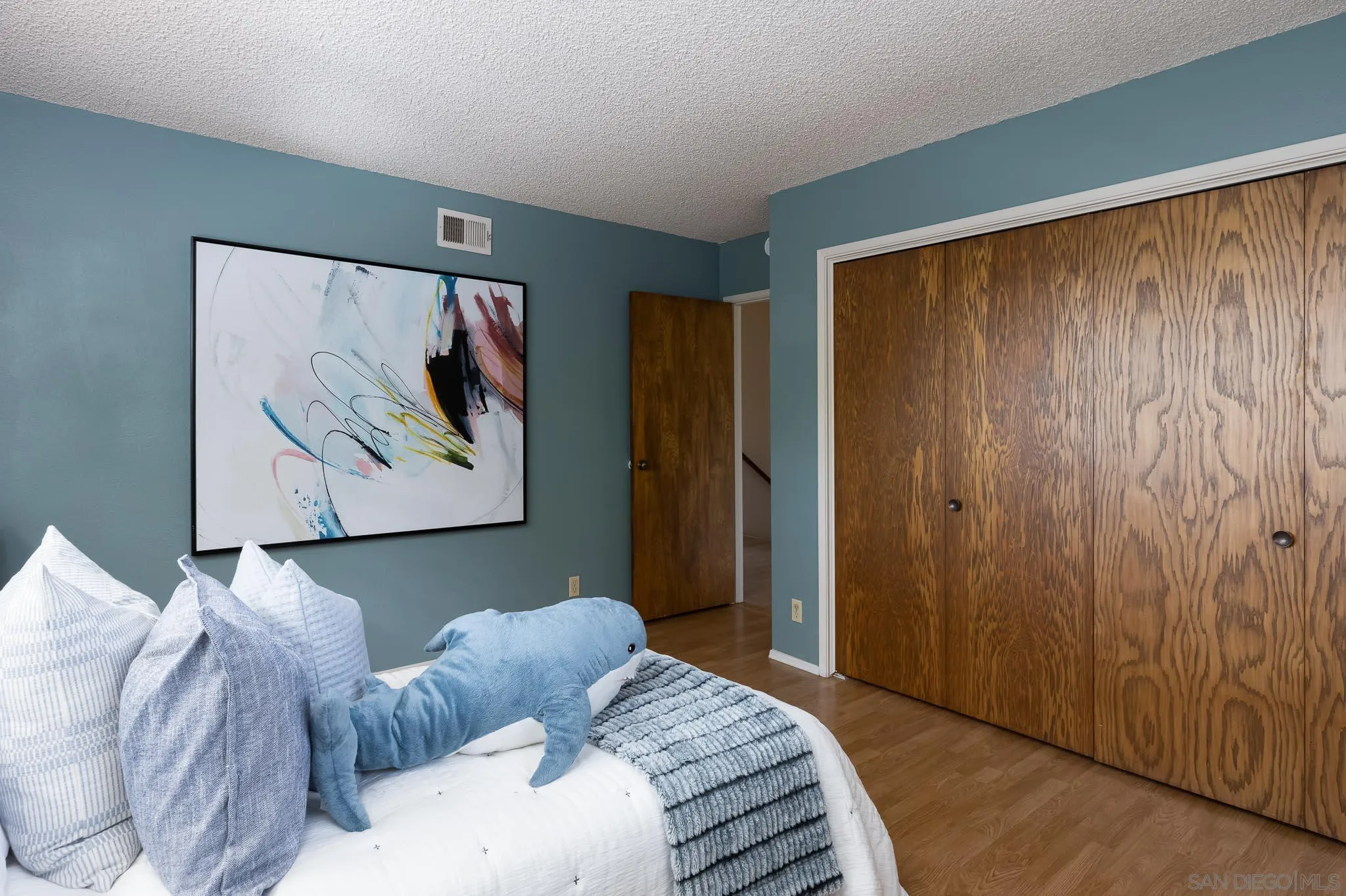 13995 Belvedere Drive Poway, CA 92064 - Photo 17 of 54 a bedroom with a bed and a painting on the wall