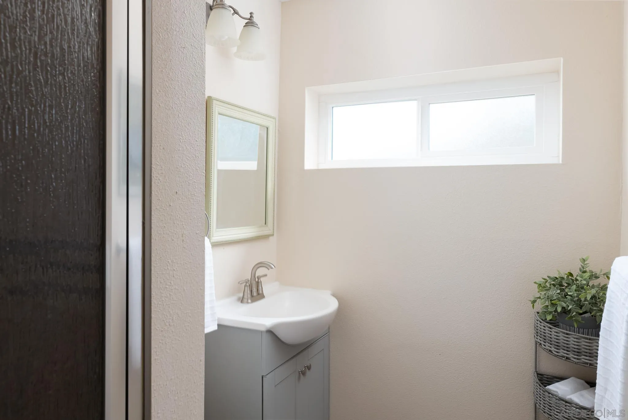 13995 Belvedere Drive Poway, CA 92064 - Photo 25 of 54 a bathroom with a sink and a mirror