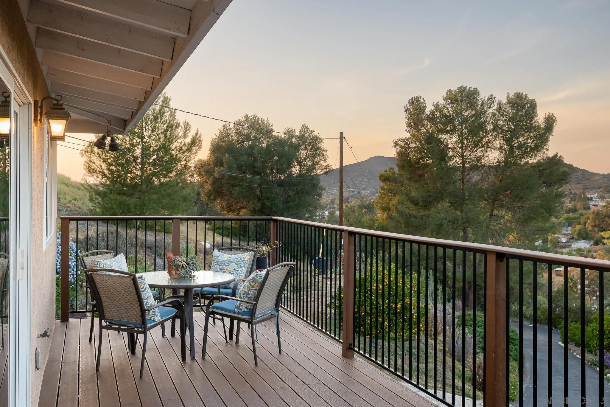 13995 Belvedere Drive Poway, CA 92064 - Photo 26 of 54 a view of a deck with table and chairs and wooden floor