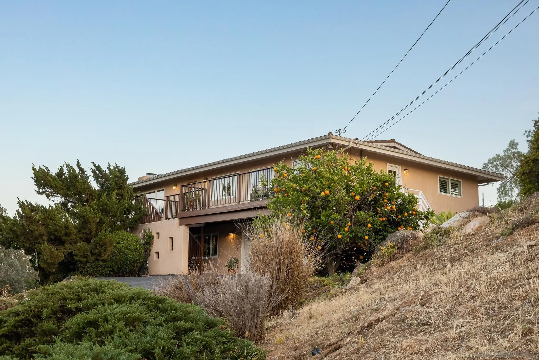 13995 Belvedere Drive Poway, CA 92064 - Photo 32 of 54 a view of a house with a small yard and plants