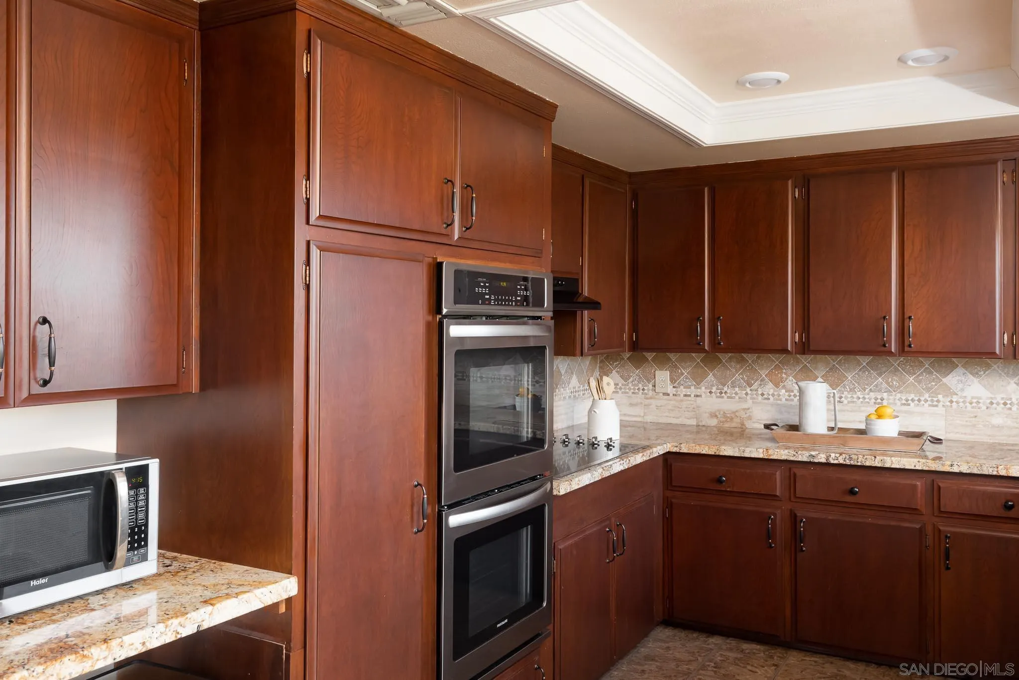 13995 Belvedere Drive Poway, CA 92064 - Photo 8 of 54 a kitchen with granite countertop stainless steel appliances and wooden cabinets