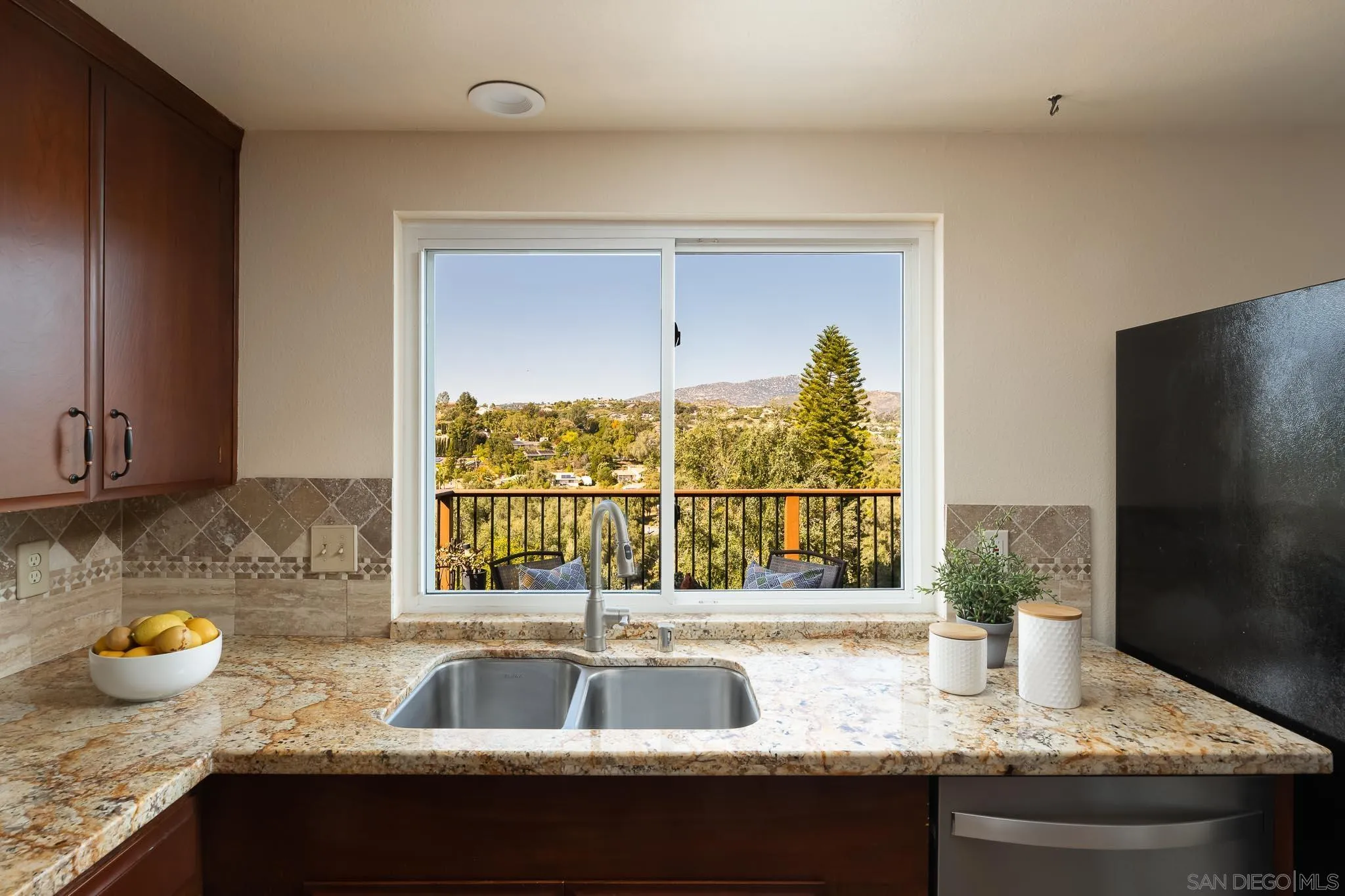13995 Belvedere Drive Poway, CA 92064 - Photo 9 of 54 a kitchen with granite countertop a sink and a window