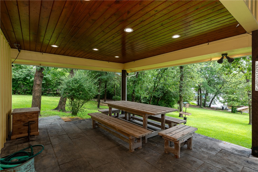 8695 Clyde Acord Road Franklin, TX 77856 - Photo 19 of 50 View of patio featuring outdoor dining area and view of scattered trees