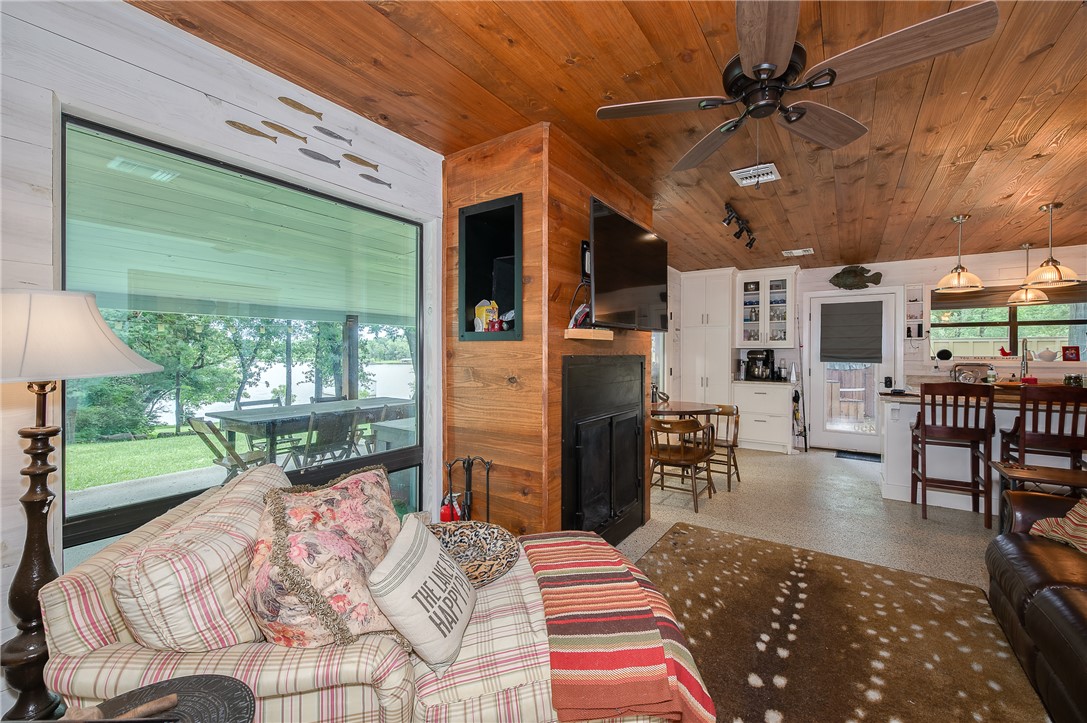 8695 Clyde Acord Road Franklin, TX 77856 - Photo 40 of 50 Living area with wooden ceiling, healthy amount of natural light, ceiling fan, and a fireplace
