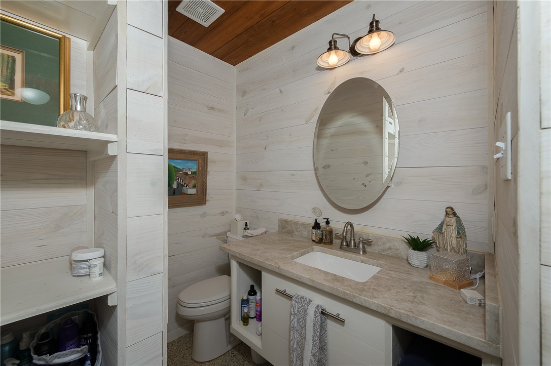 8695 Clyde Acord Road Franklin, TX 77856 - Photo 44 of 50 Half bath featuring vanity, wood ceiling, and wood walls