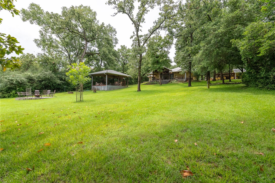 8695 Clyde Acord Road Franklin, TX 77856 - Photo 10 of 50 Yard with covered dining/gathering area