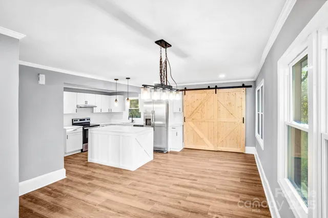 a view of a kitchen with a sink and wooden floor