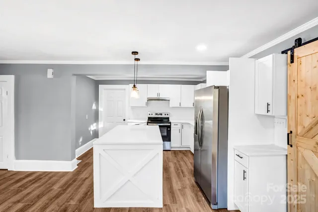a kitchen with stainless steel appliances a refrigerator sink and stove