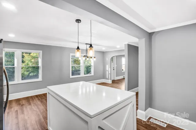 a kitchen with a sink a stove a refrigerator and cabinets