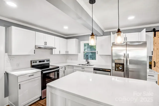 a view of a hallway with wooden floor and a living room