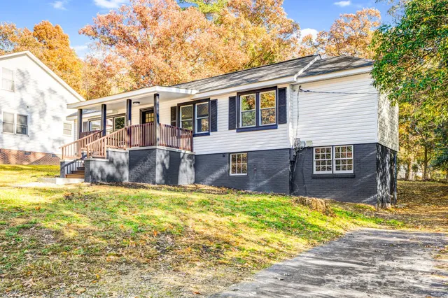 a house view with swimming pool in front of it