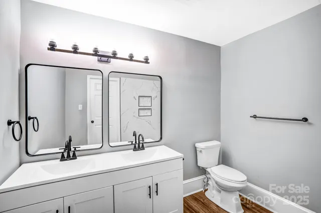 a view of a room with wooden floor and a window