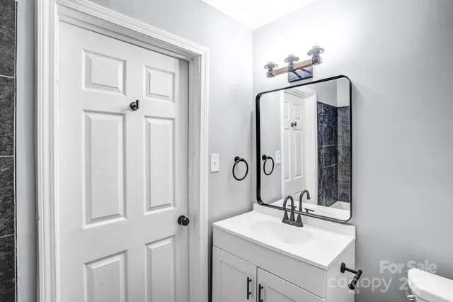 a small space with wooden floor and a bathroom