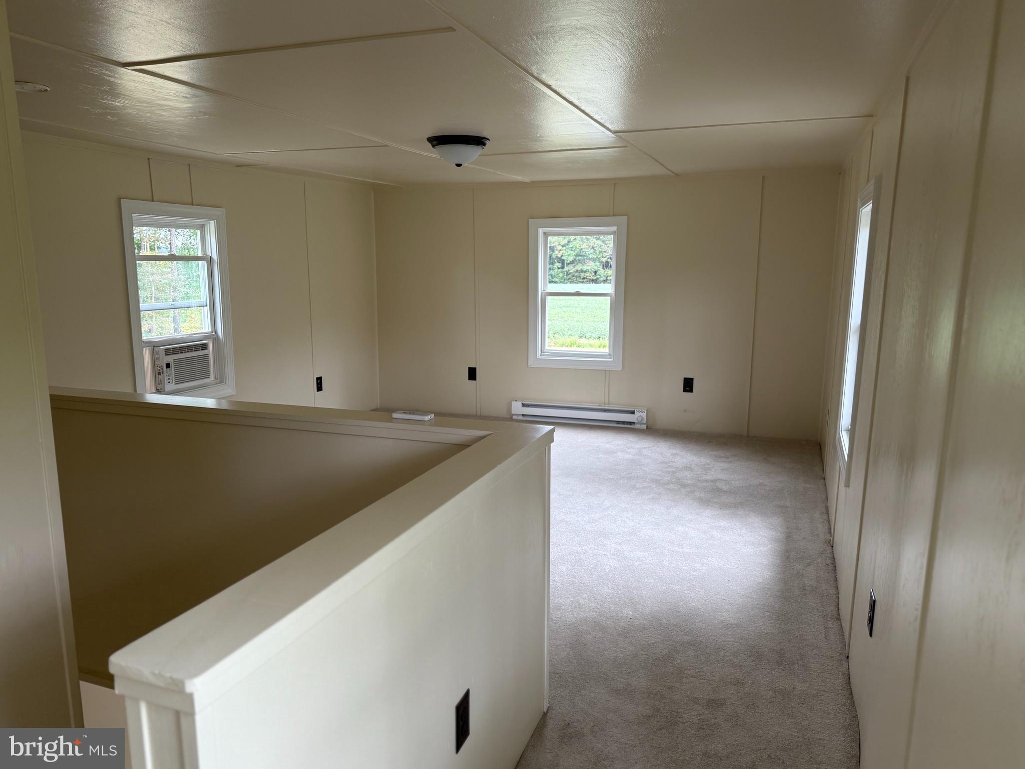 6028 Cornstack Road Marion Station, MD 21838 - Photo 12 of 13 a view of an empty room with window and wooden floor