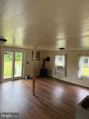 a view of a livingroom with furniture wooden floor and windows