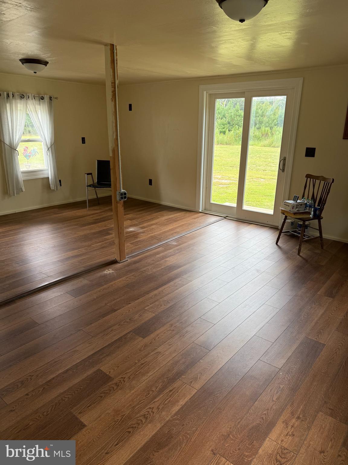 6028 Cornstack Road Marion Station, MD 21838 - Photo 6 of 13 a view of a room with wooden floor and a window