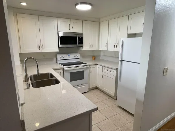 a kitchen with a refrigerator sink and microwave