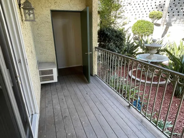 a view of balcony with wooden floor