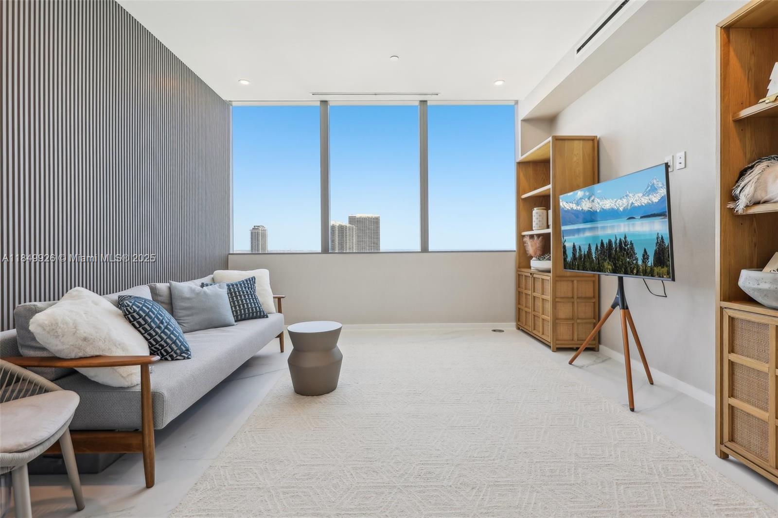 2000 South Ocean Drive, Unit 28A Hallandale Beach, FL 33009 - Photo 19 of 66 a living room with furniture and a flat screen tv