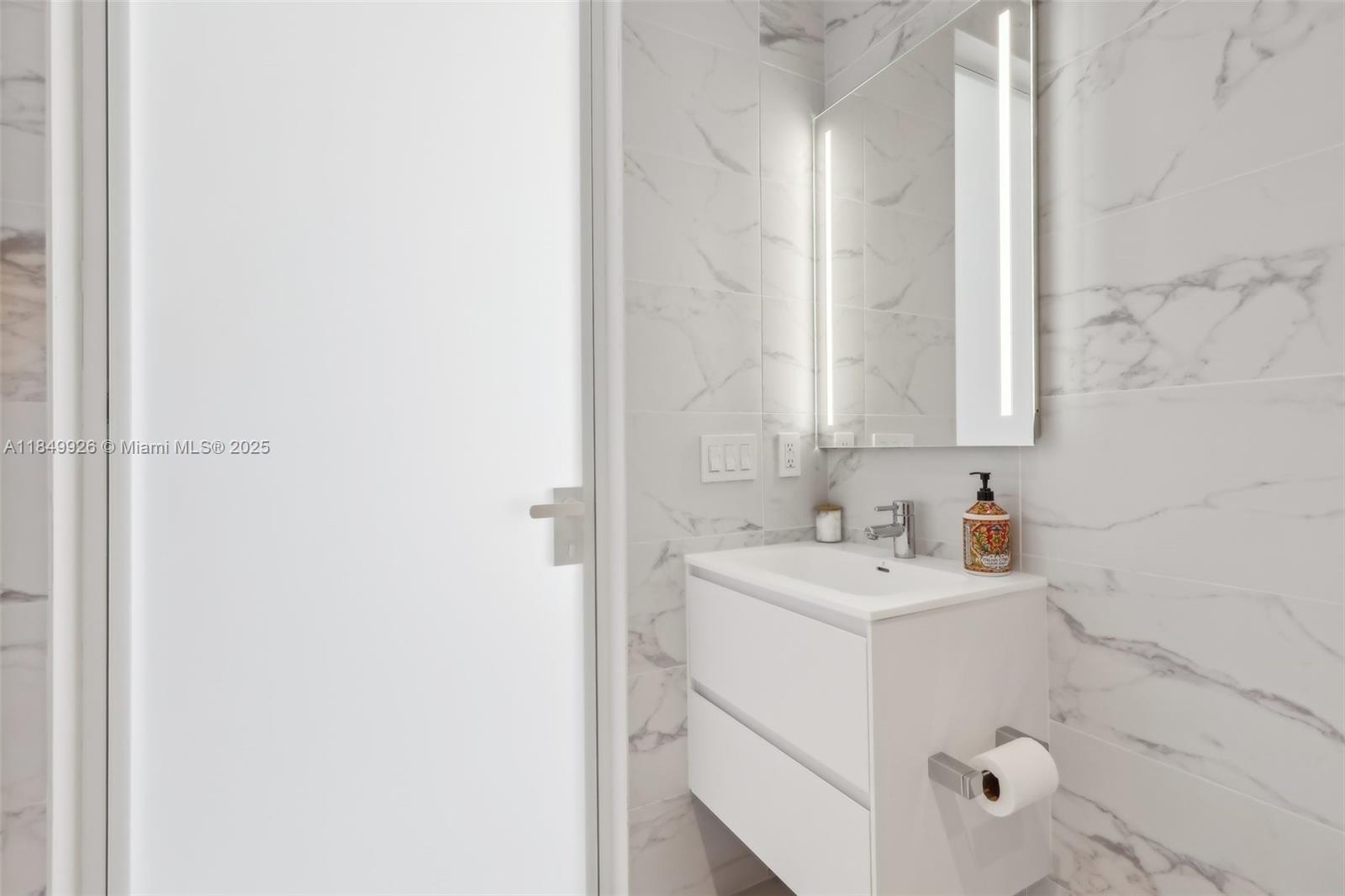 2000 South Ocean Drive, Unit 28A Hallandale Beach, FL 33009 - Photo 37 of 66 a bathroom with a sink and a mirror