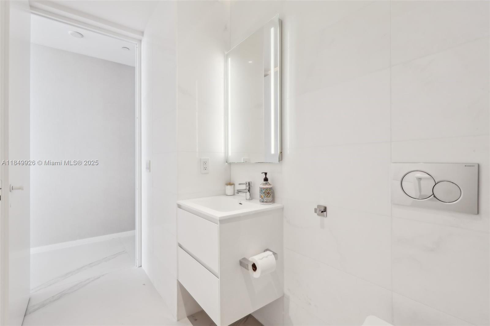 2000 South Ocean Drive, Unit 28A Hallandale Beach, FL 33009 - Photo 44 of 66 a bathroom with a sink a mirror and a bathtub