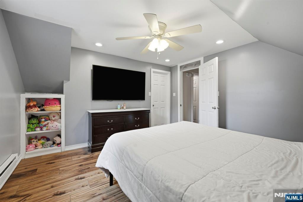 52 Barbara Drive Pompton Lakes, NJ 07442 - Photo 20 of 30 a bedroom with a bed and a flat screen tv